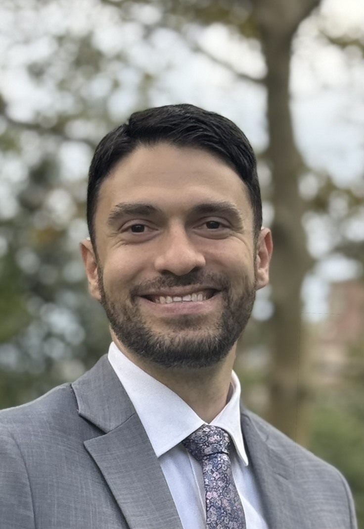 Jacob Jove smiling in a suit